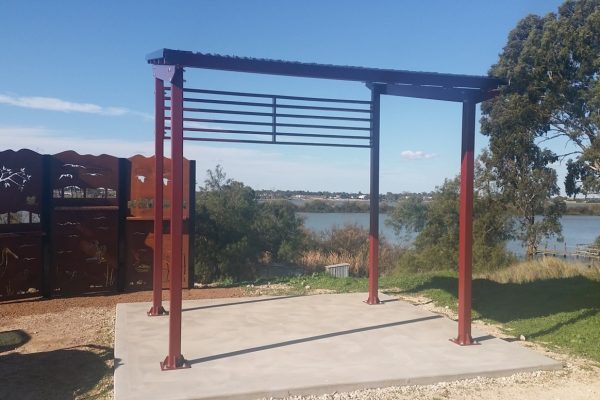 Decorative metal bird hide and shelter looking over wetland