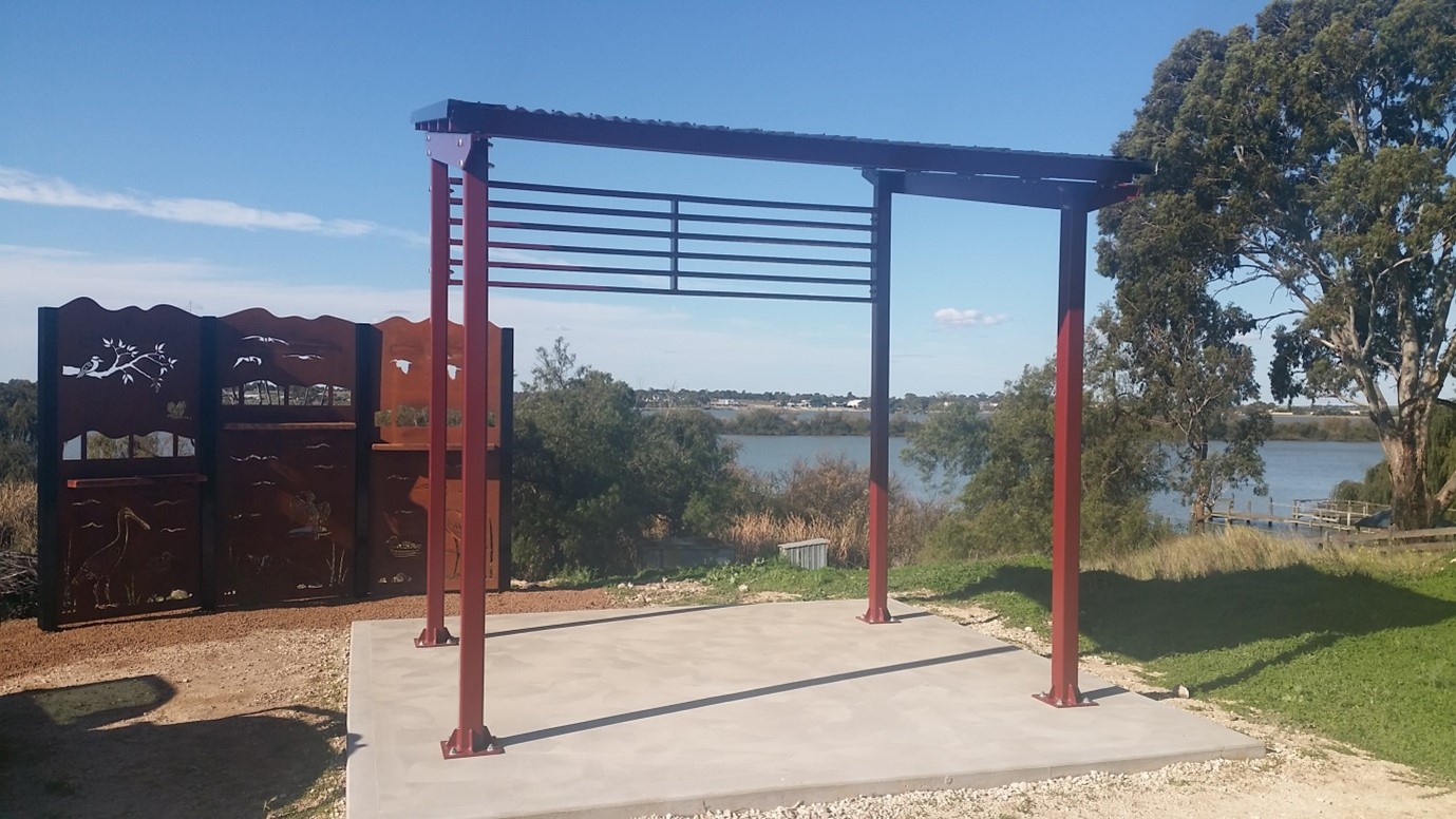 Decorative metal bird hide and shelter looking over wetland
